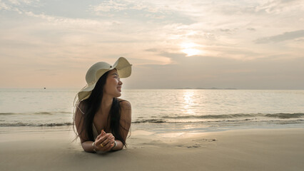 Bikini model woman relaxing sunbathing on sand beach