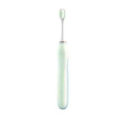 Close up shot of a light green electric toothbrush with a white head on a white background isolated view