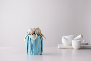 Elegant Korean table setting with traditional Korean bojagi gift wrapping for Chuseok, ceramic vase...