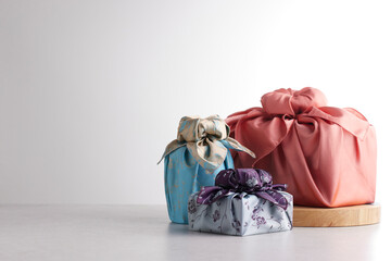 Elegant Korean table setting with traditional Korean bojagi gift wrapping for Chuseok, ceramic vase...