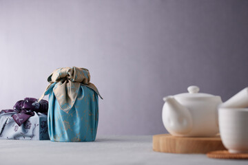 Elegant Korean table setting with traditional Korean bojagi gift wrapping for Chuseok, ceramic vase...