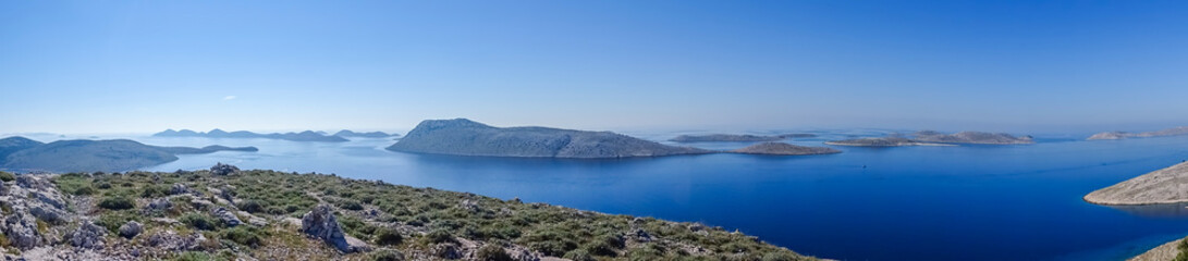 Wide panoramic view of Kornati National Park in Croatia, showing numerous rocky islands and deep...