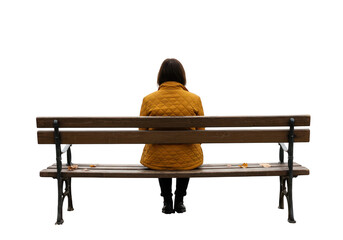 A woman in a yellow coat sits on a park bench in autumn, isolated on transparent background