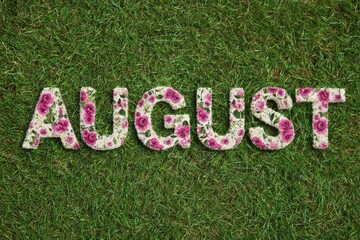 Floral AUGUST text on green grass