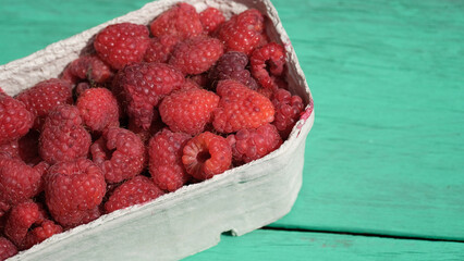 Raspberries, Fresh Organic Berries in Carton Box on Wooden Background