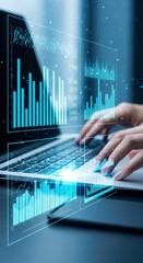 Hands typing on laptop with glowing blue financial data charts and graphs technology analysis