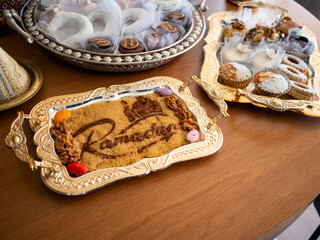 A beautifully arranged platter of traditional arabic sweets takes center stage at a lively...