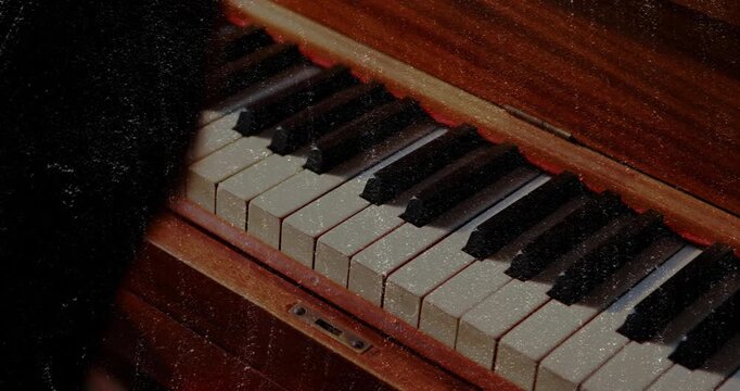 Girl initiating piano melody by pressing mid-range key and gliding right for music education