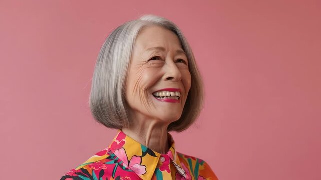 An elderly woman radiates joy and contentment in this image. Her vibrant clothing adds to the cheerful atmosphere, suggesting a positive attitude towards life despite her age.