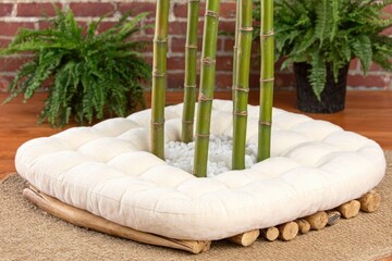 Bamboo plants in a white cushion, nestled on a woven mat