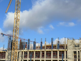 Construction site with cranes on blue sky background
