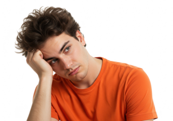 A young man with messy hair, wearing an orange tshirt, rests his head on his hand looking bored, isolated on transparent background