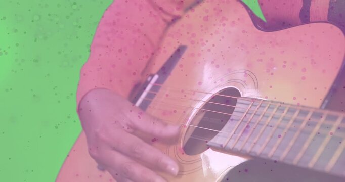 Artist's fingers hovering then plucking and strumming guitar strings speckle overlay for music demo