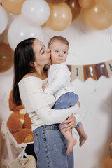 Mother and child cherish a joyful moment during a birthday celebration indoors