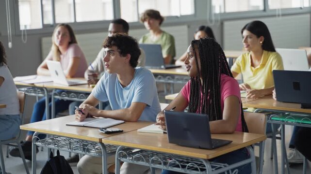 Diverse college Students focused listening to teacher lecture, learning at High School