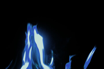 Close up blue flames on black background for graphic design or wallpaper.