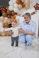 Celebration of a toddler's first steps with loving grandmother in a joyful indoor setting