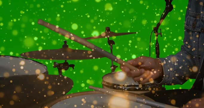 Drummer initiating drum pattern with wooden sticks for music on green screen syncing gold bokeh