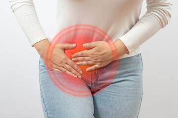Woman holding lower abdomen from side. Pain or spasm. Gynecological problems or appendicitis
