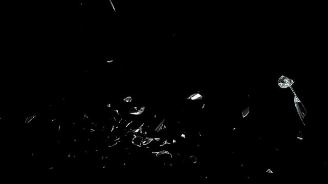 A crystal champagne glass falls and breaks into flying glass fragments, including the bowl, stem, and base. The animation shows the shattering process with realistic reflections on transparent
