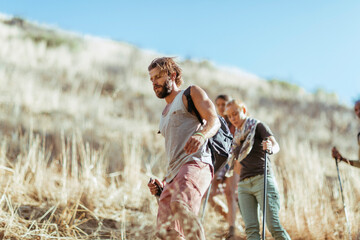 Young and diverse group of friends and hikers hiking together in the mountains of south africa
