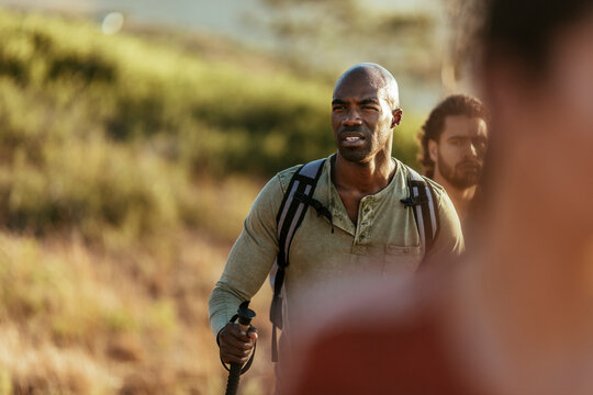 Young and diverse group of friends and hikers hiking together in the mountains of south africa - Powered by Adobe