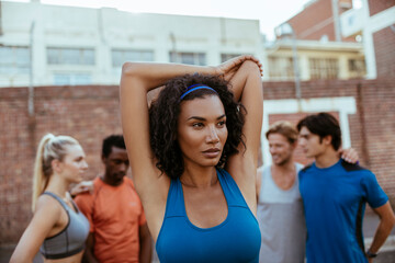 Diverse group of young people preparing and getting ready to go jogging and running in the city