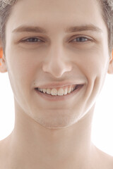 Close-Up Of Smiling Young Man With Bright Expression Against White Background 