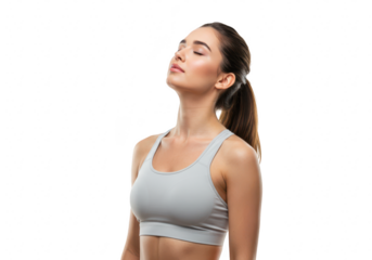 A fit woman in a sports bra takes a deep, peaceful breath with her eyes closed, isolated on white isolated on transparent background