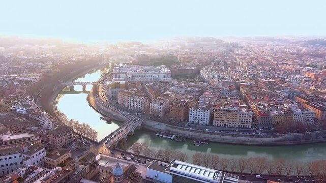 Breathtaking aerial sunrise footage of Rome&rsquo;s Tiber River winding past the modern Ara Pacis Museum, circular mausoleum, framed by bridges, terracotta rooftops historic streets and golden sunrise glow.