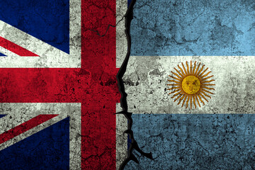 UK vs Argentina conflict concept with both flags painted on the wall.