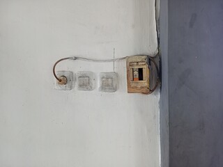 Electrical Outlets and Fuse Box on White Wall