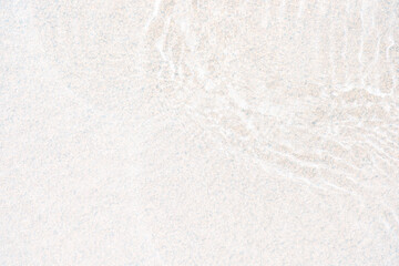 White water with ripples on the surface. Defocus blurred transparent white colored clear calm water surface texture with splashes and bubbles. Water waves with shining pattern texture background.