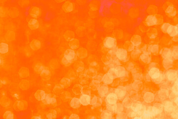 Golden orange bokeh background with soft glowing highlights. Blurred circles of light create a...
