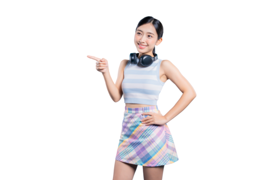 A happy young Asian woman with headphones around her neck, pointing to the side to show or recommend something.on png  
