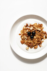 Natural Greek Yogurt with Homemade Granola with Nuts, Seeds, and Raisins, and Black Currants on Top. Breakfast Food.