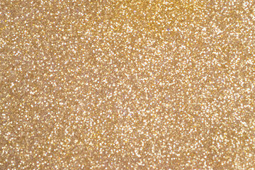 Golden bokeh background with soft glowing highlights. Blurred circles of light create a festive and warm atmosphere. Great for designs, cards and backgrounds