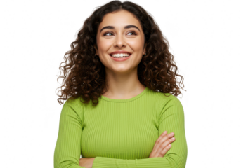 A young woman with curly brown hair and a green longsleeved shirt smiles confidently with her arms crossed, isolated on white isolated on transparent background