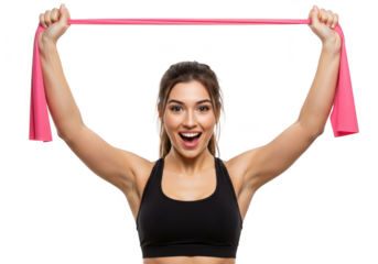 A fit woman with a joyful expression holds a pink resistance band overhead, isolated on a transparent background