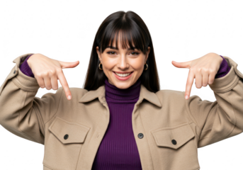 A young woman with dark hair and bangs smiles and points down with both index fingers, isolated on a transparent background