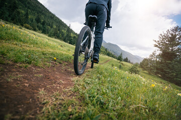 Riding mountain bike on grassland forest mountains