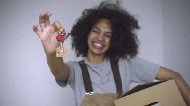 The radiant woman proudly displays her freshly acquired house keys. - Powered by Adobe