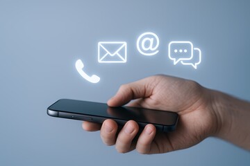 Modern smartphone holding hand with digital communication icons like email chat and phone.