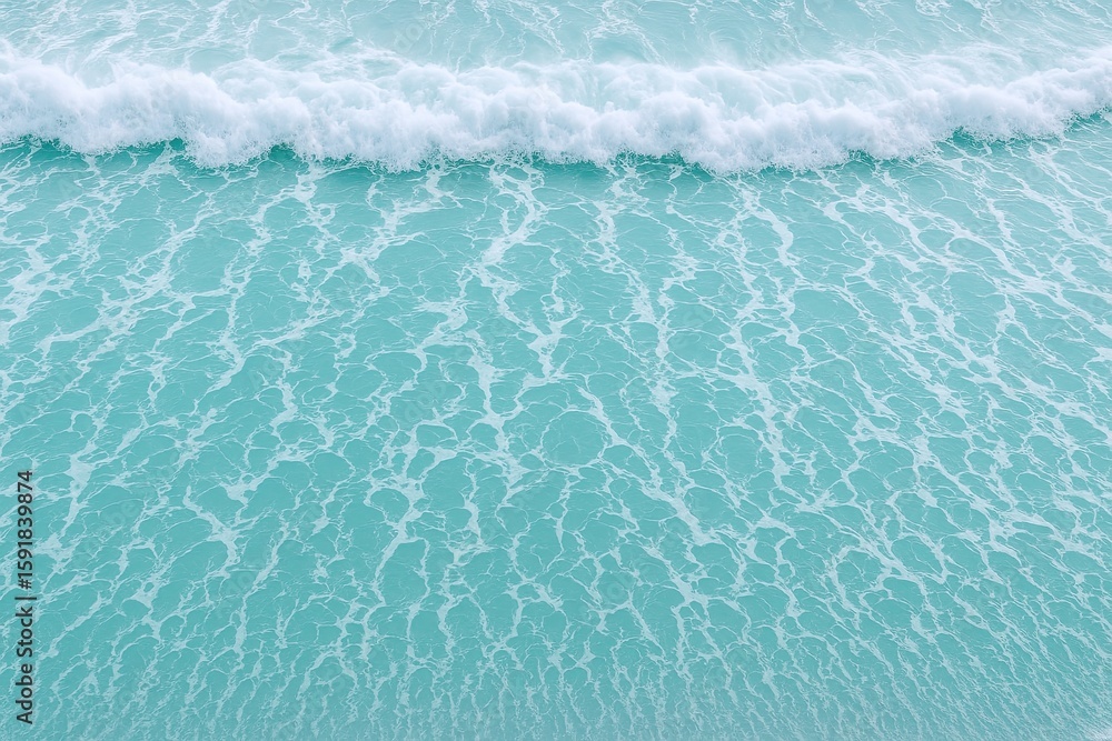Aufkleber aerial view of ocean waves crashing into turquoise water with white foam pattern.