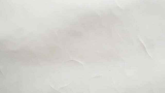 Textured white background with subtle creases and shadows, a neutral abstract surface