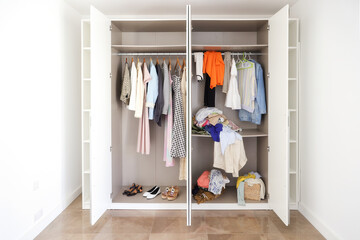 Open Wardrobe with Neat and Messy Clothes
