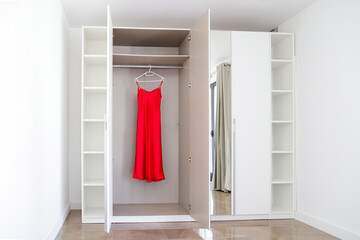Open Wardrobe with Red Dress Hanging Inside