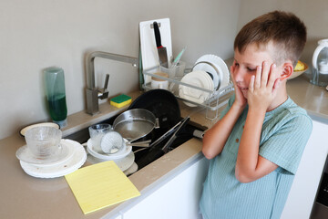 Boy Looks Worried at Messy Kitchen Sink
