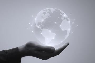 Futuristic hand holding a glowing digital globe representing global connectivity and technology.