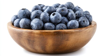Fresh, plump blueberries fill a rustic wooden bowl, glistening with dew drops on a white table.